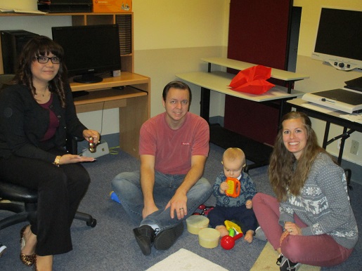 A family is exploring all of the sounds at the music station